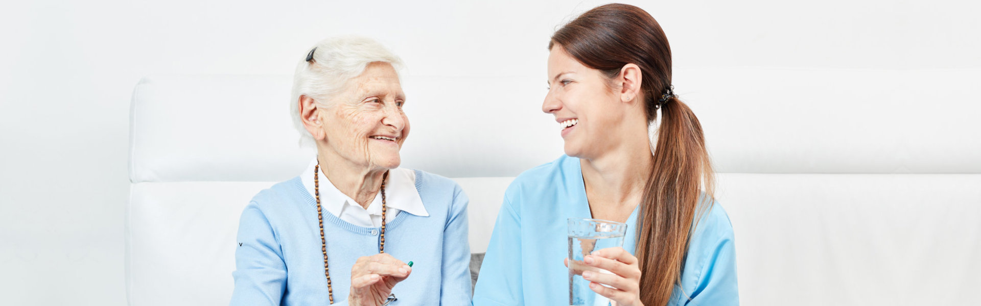 nurse and senior smiling at each other