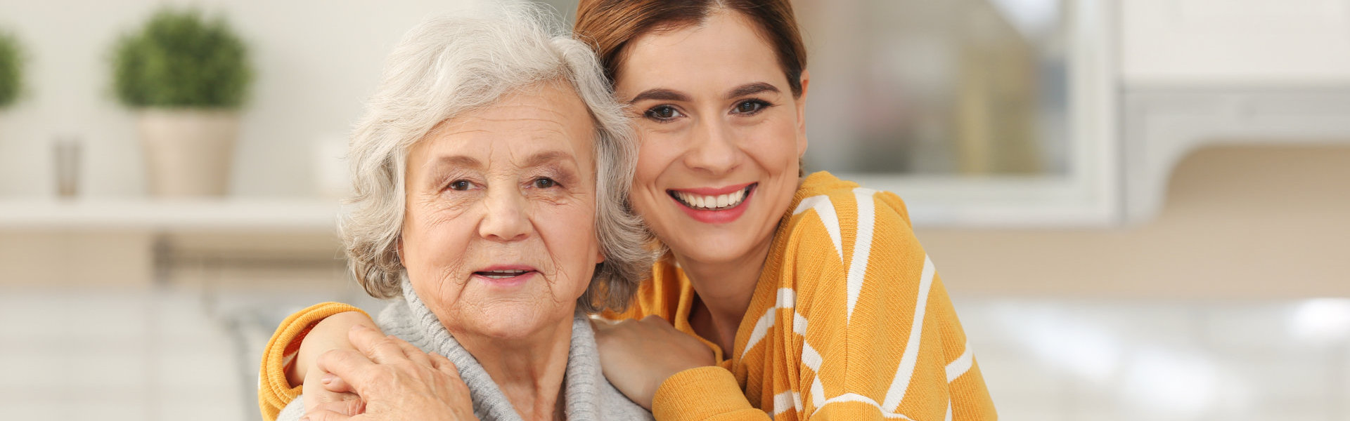 nurse and senior smiling at the camera